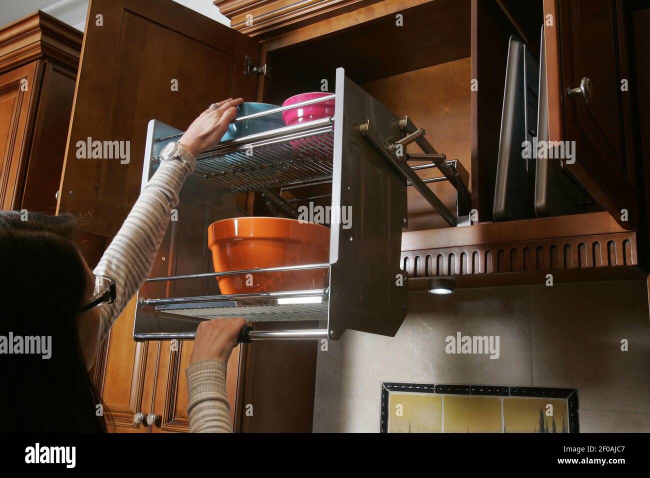 A convenient pull down rack maximizes space usage in an upper kitchen