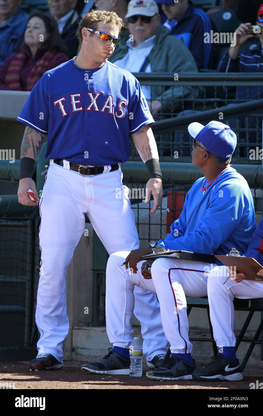 The Texas Rangers' Josh Hamilton, left, pauses to talk with