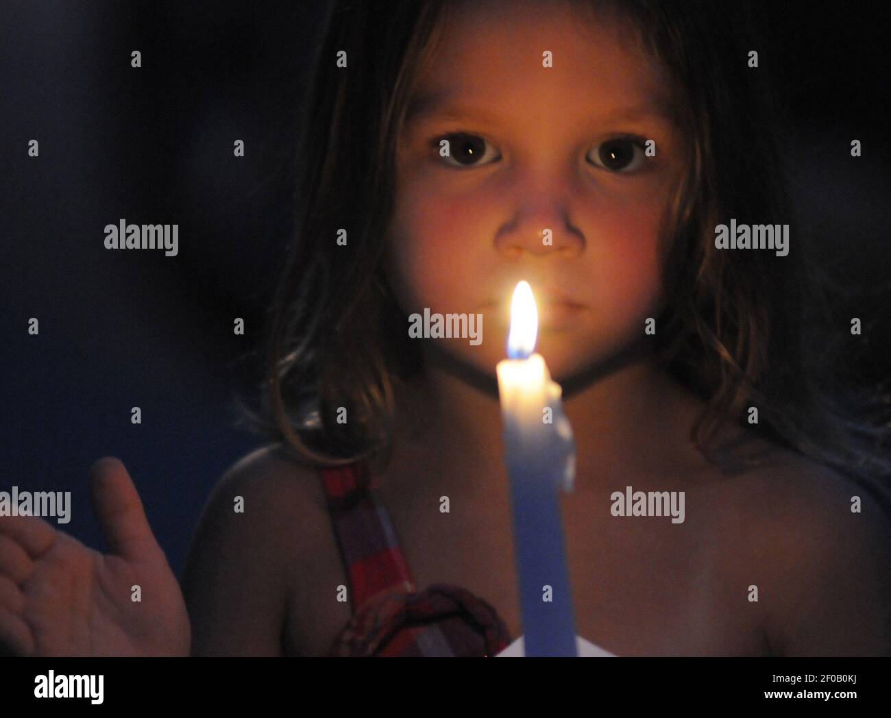 Alyssa Sparks holds a candle during a candlelight vigil Monday night