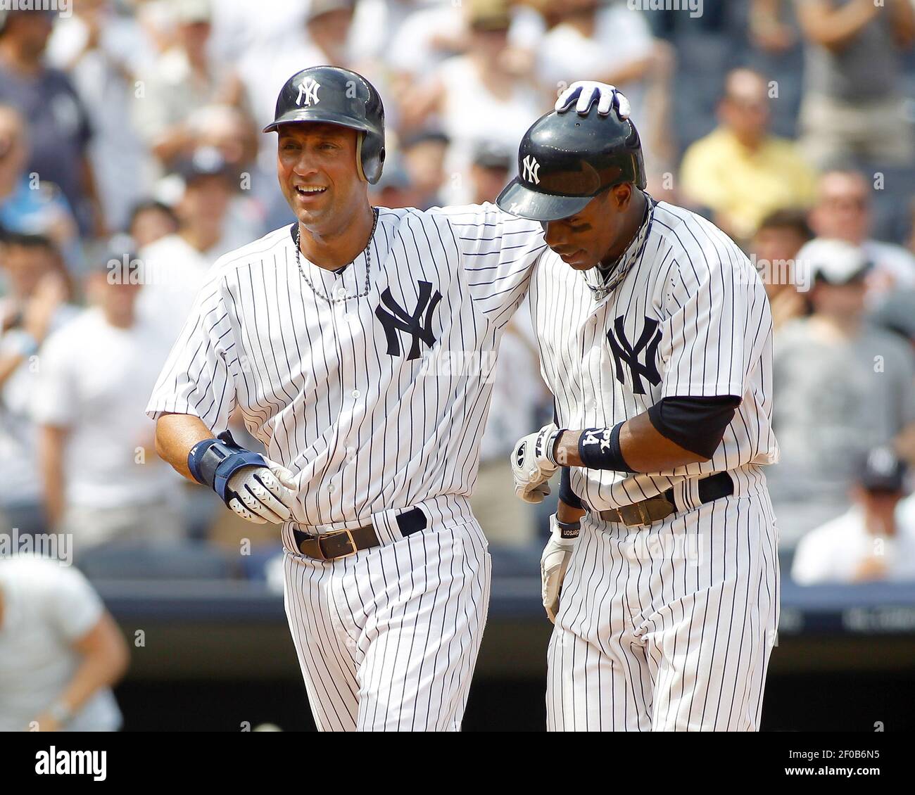 New York Yankees' Derek Jeter congratulates Curtis Granderson on his  two-run homer against the Oakland Athletics' in the fifth inning at Yankee  Stadium in New York, Sunday, July 24, 2011. (Photo by