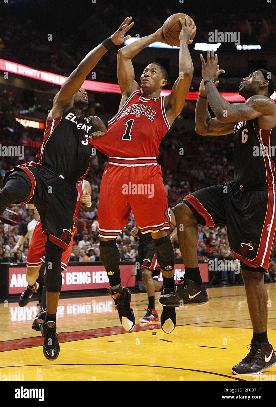 Miami Heat's Dwyane Wade and LeBron James guard Chicago Bulls' Derrick Rose  as he makes a third-quarter basket, Sunday, March 6, 2011, at the American  Airlines Arena in Miami, Florida. The Bulls