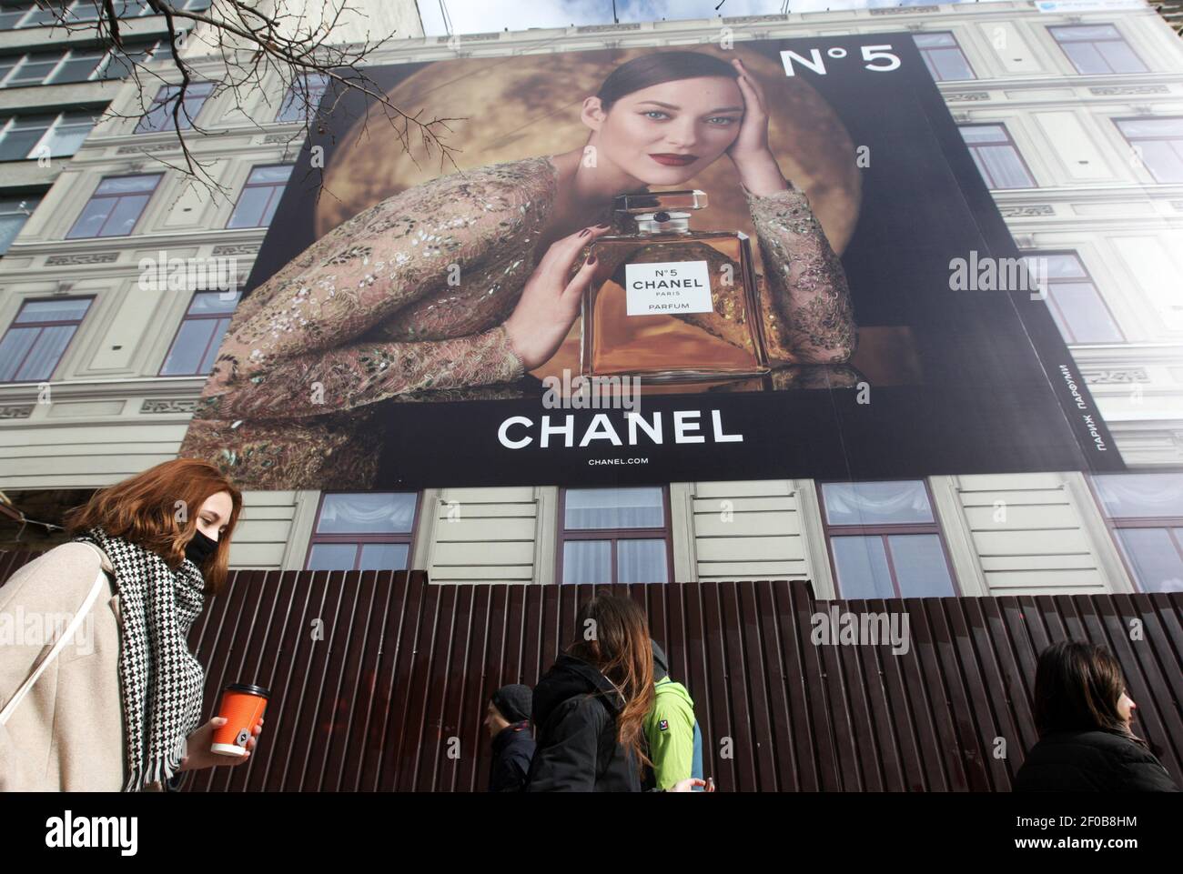 Kiev, Ukraine. 06th Mar, 2021. People walk past Chanel parfumery  advertising board that is seen placed on a building in Kiev, Ukraine.  Credit: SOPA Images Limited/Alamy Live News Stock Photo - Alamy