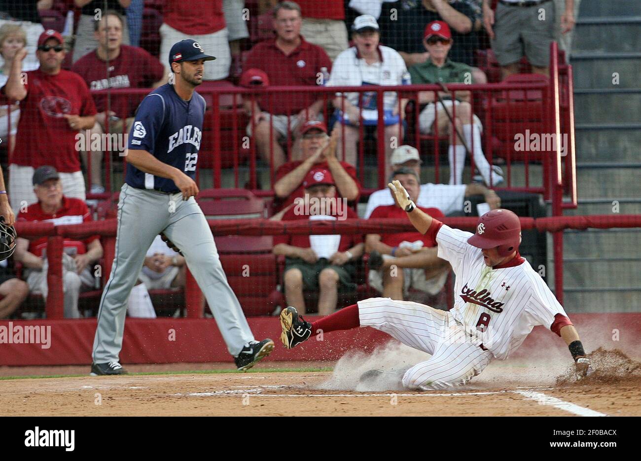 South Carolina's Scott Wingo, left, exchanges high fives with teammate Jackie  Bradley, Jr., after Wingo scored against Texas A&M on a throwing error in  the first inning of an NCAA College World