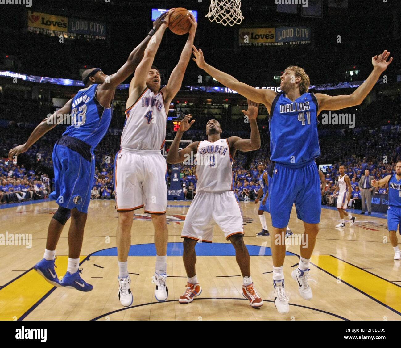 Oklahoma City Thunder power forward Nick Collison (4) puts up a layup  between Dallas Mavericks center Brendan Haywood (33) and Dirk Nowitzki in  the first half during Game 4 of the NBA