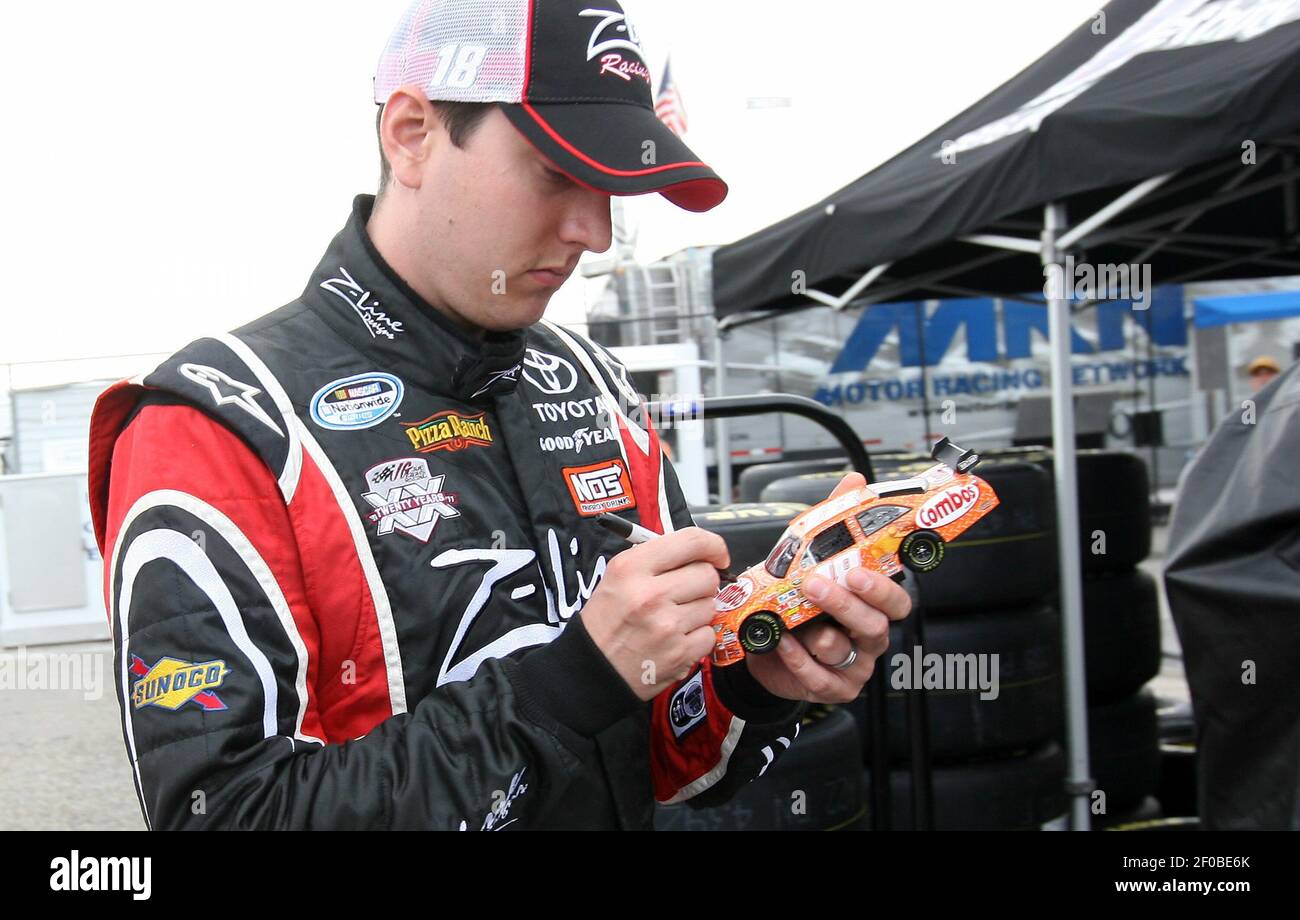 Kyle Busch autographs a toy car amid qulifying runs for the Showtime