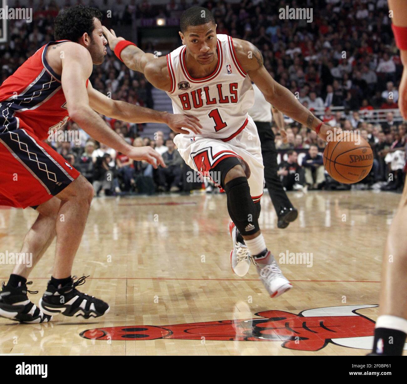 Chicago Bulls point guard Derrick Rose (1) drives around New Jersey Nets  point guard Jordan Farmar (2) during the first half of their game at the  United Center in Chicago, Illinois, on