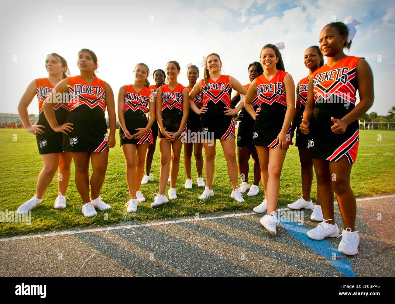 Leesburg JV cheerleaders listen to their coach after a JV high school football game was canceled