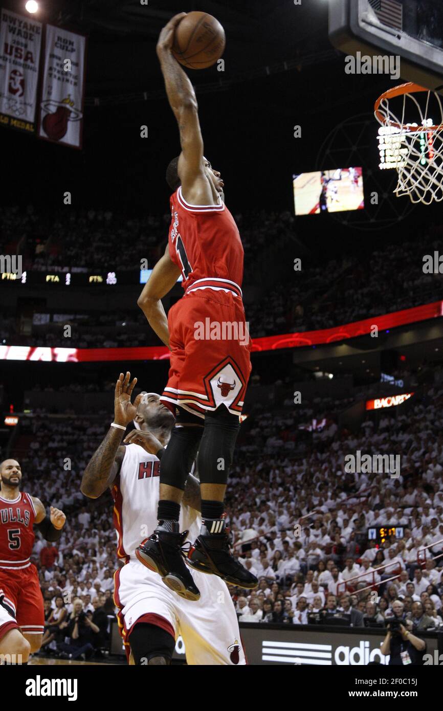 Chicago Bulls' Derrick Rose (1) dunks over Miami Heat's LeBron James during  the first quarter in Game 4 of the NBA's Eastern Conference finals at the  American Airlines Arena in Miami, Florida,