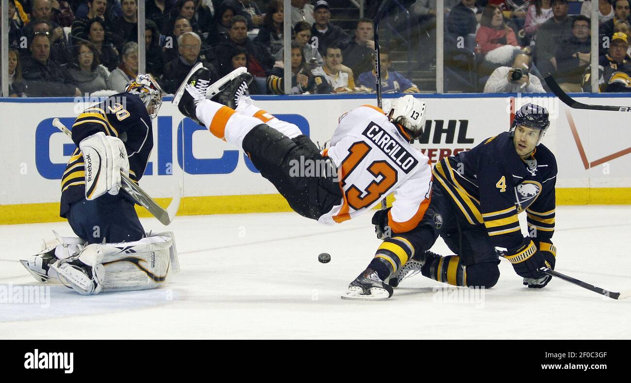 The Philadelphia Flyers' Dan Carcillo (13) falls down against Buffalo Sabres' goalie Ryan Miller, left, and Steve Montador during the first period in Game 4 of the Eastern Conference quarterfinals at HSBC Arena in Buffalo, New York, on Wednesday, April 20, 2011. (Photo by Yong Kim/Philadelphia Daily News/MCT/Sipa USA) Stock Photo