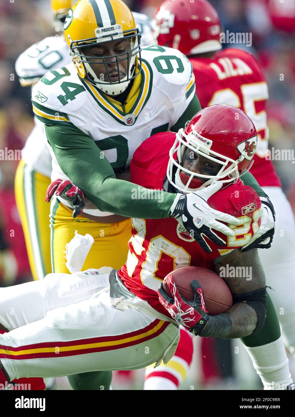 Green Bay Packers defensive end Jarius Wynn (94) stops Kansas City Chiefs  running back Thomas Jones (20) on a run in the third quarter during  Sunday's football game at Arrowhead Stadium on