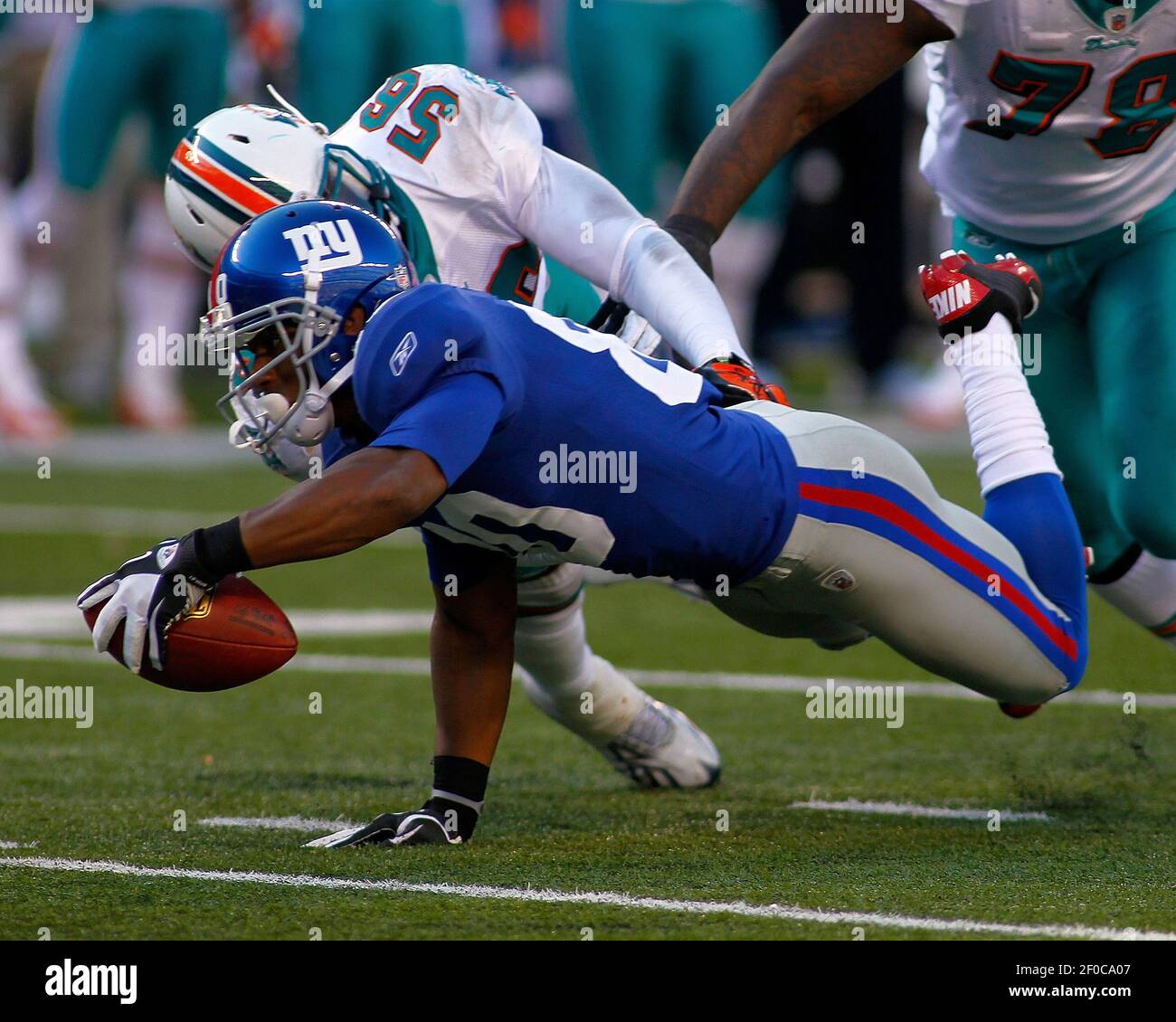 New York Giants' Victor Cruz stretches for a first down against Miami  Dolphins' Kevin Burnett in the fourth quarter. The New York Giants defeated  the Miami Dolphins, 20-17, at MetLife Stadium in