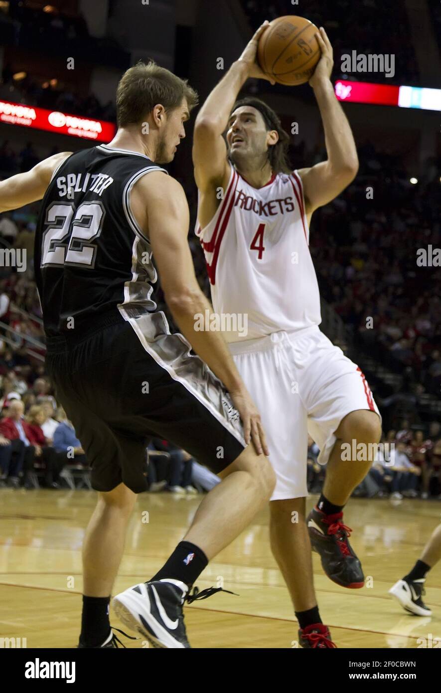 Houston Rockets' Luis Scola (4) is fouled by the Los Angeles