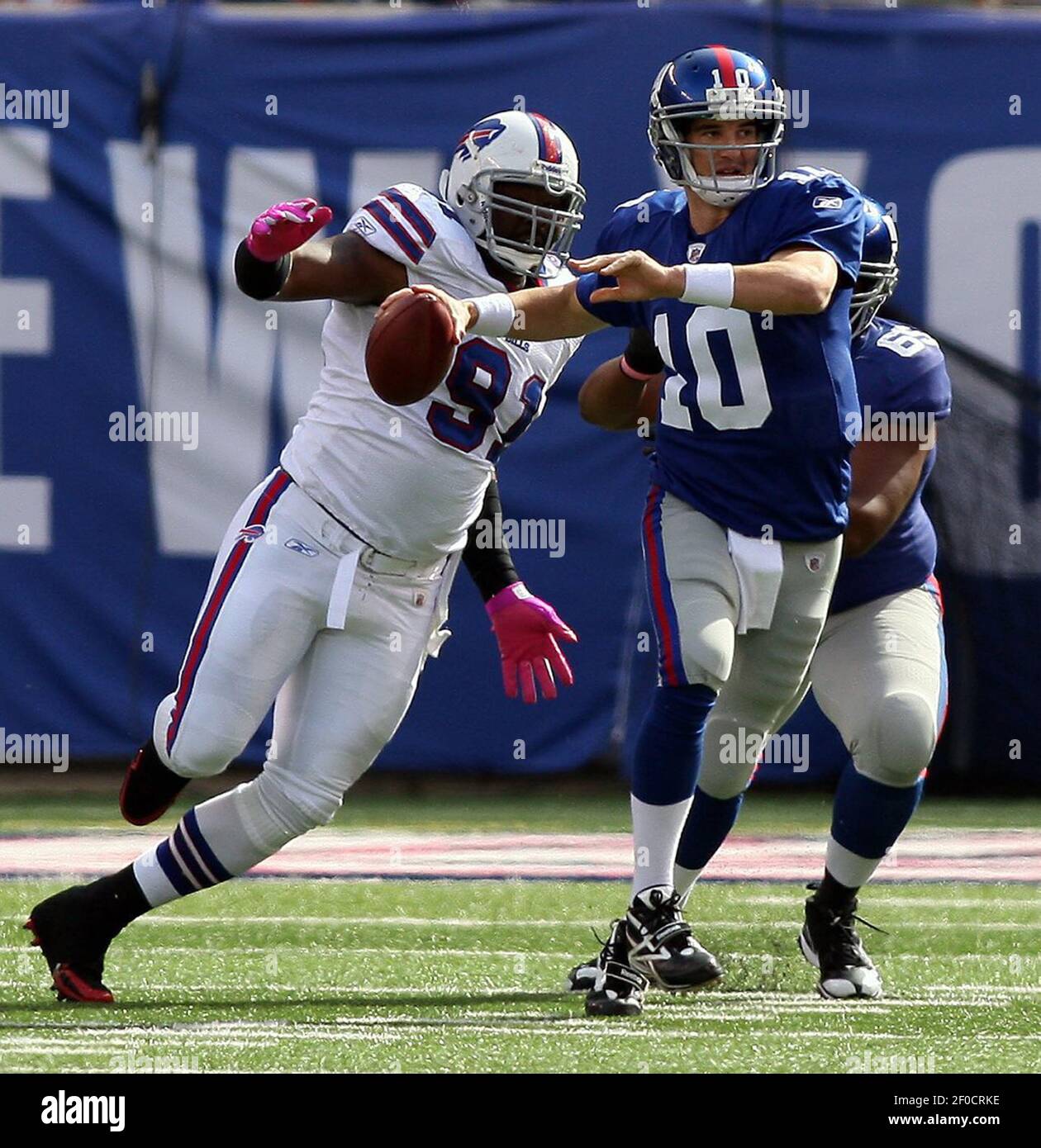 New York Giants quarterback Eli Manning is chased down by Buffalo Bills  Spencer Johnson at MetLife Stadium in East Rutherford, New Jersey, Sunday,  October 16, 2011. The Giant defeated the Bills, 27-24. (