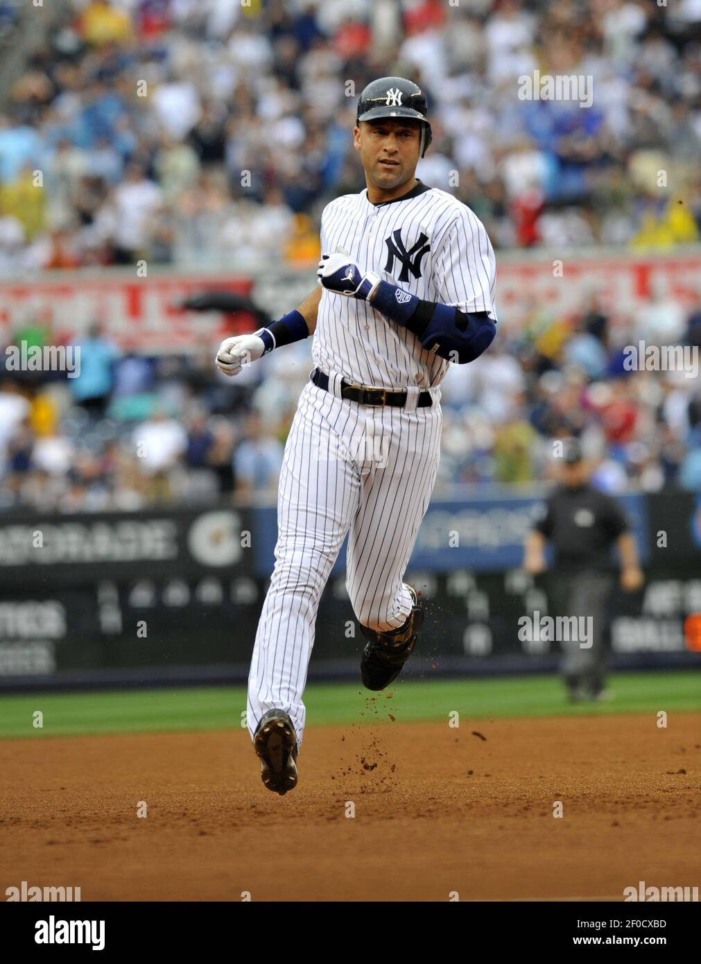 Derek Jeter of the New York Yankees heads to third for a stand-up