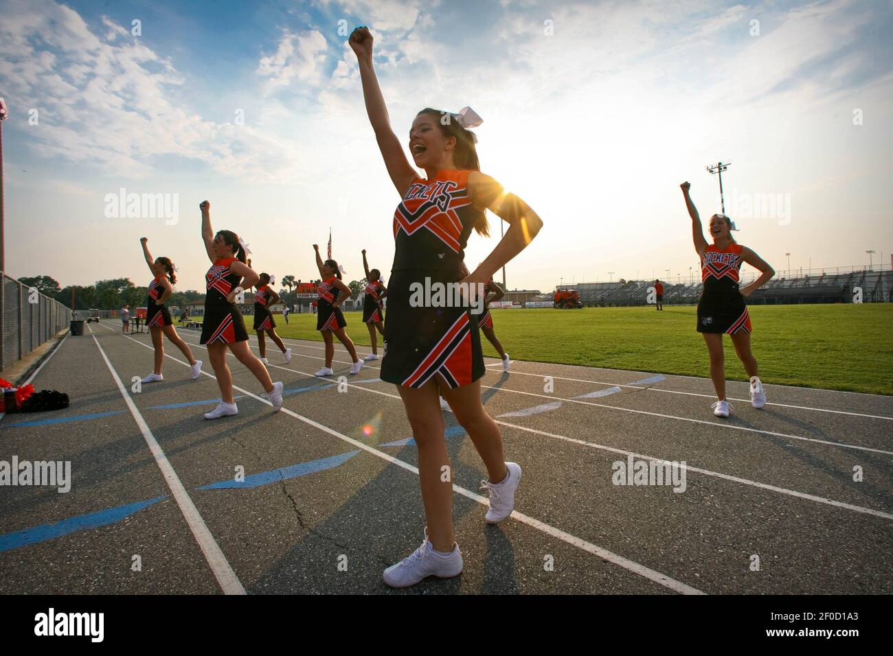 Leesburg JV cheerleaders perform a drill for the camera after a JV high school football game was