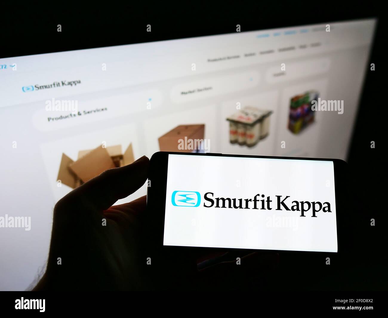 Person holding smartphone with logo of Irish packaging company Smurfit Kappa  Group plc on screen in front of website. Focus on phone display Stock Photo  - Alamy