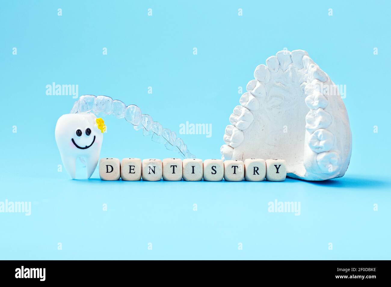 Dentist lettering for your advertisement on a blue background with invisible dental aligners or