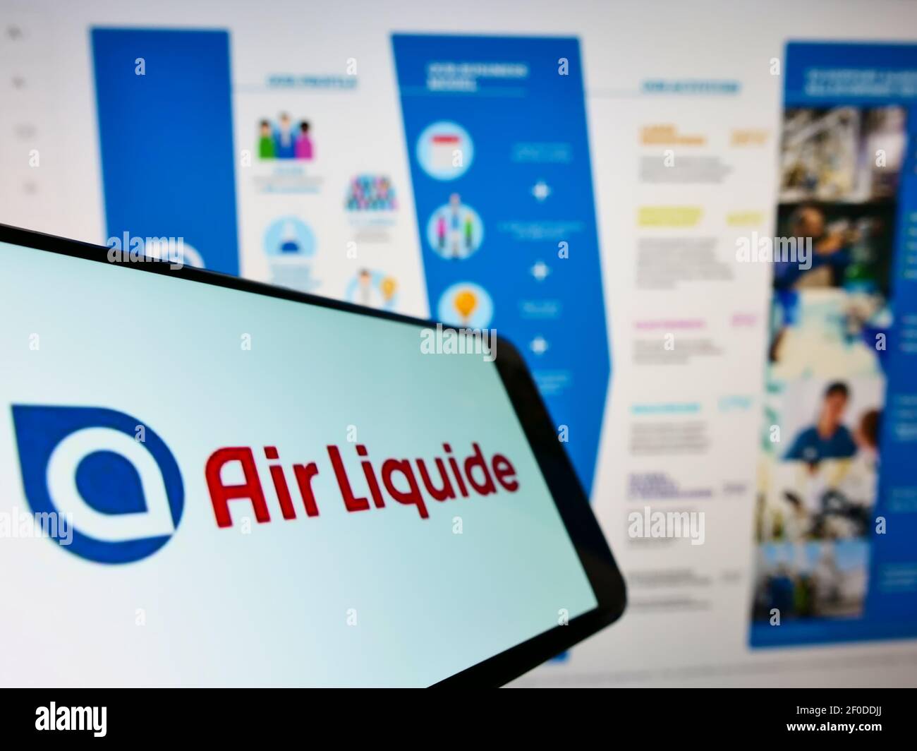 Smartphone with business logo of French chemical company Air Liquide S.A. on screen in front of website. Focus on center of phone display. Stock Photo