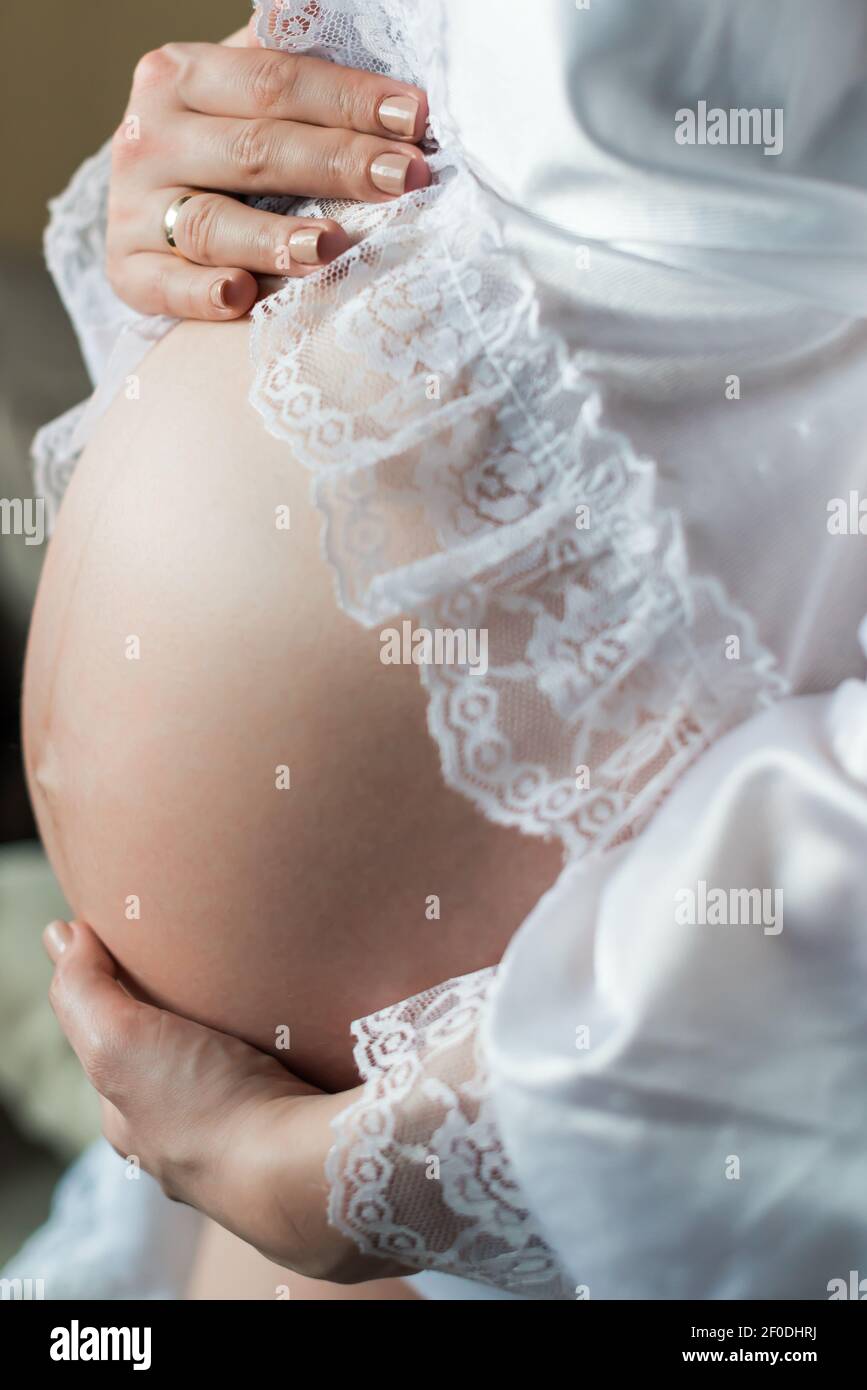 Pregnant woman holding belly Stock Photo