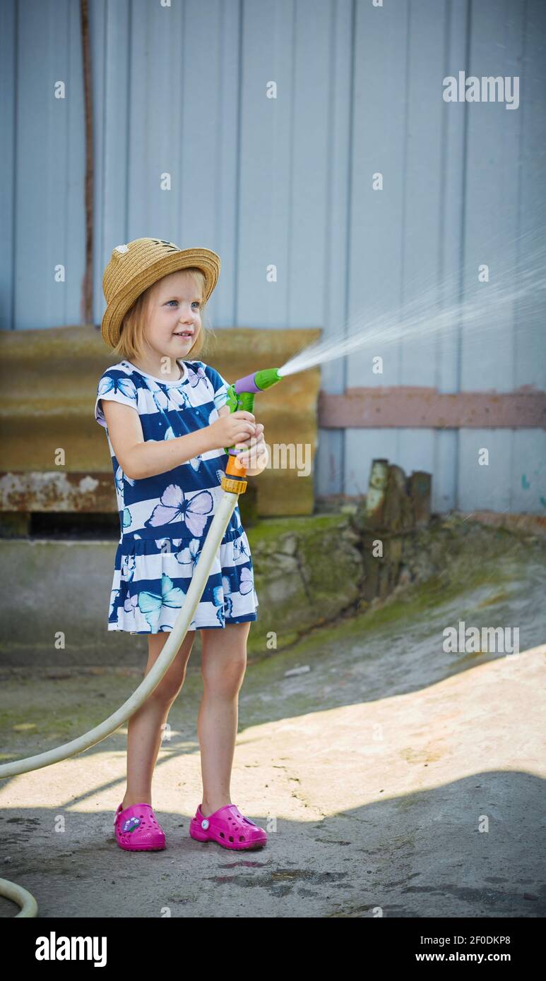 Girl watering garden hires stock photography and images Alamy
