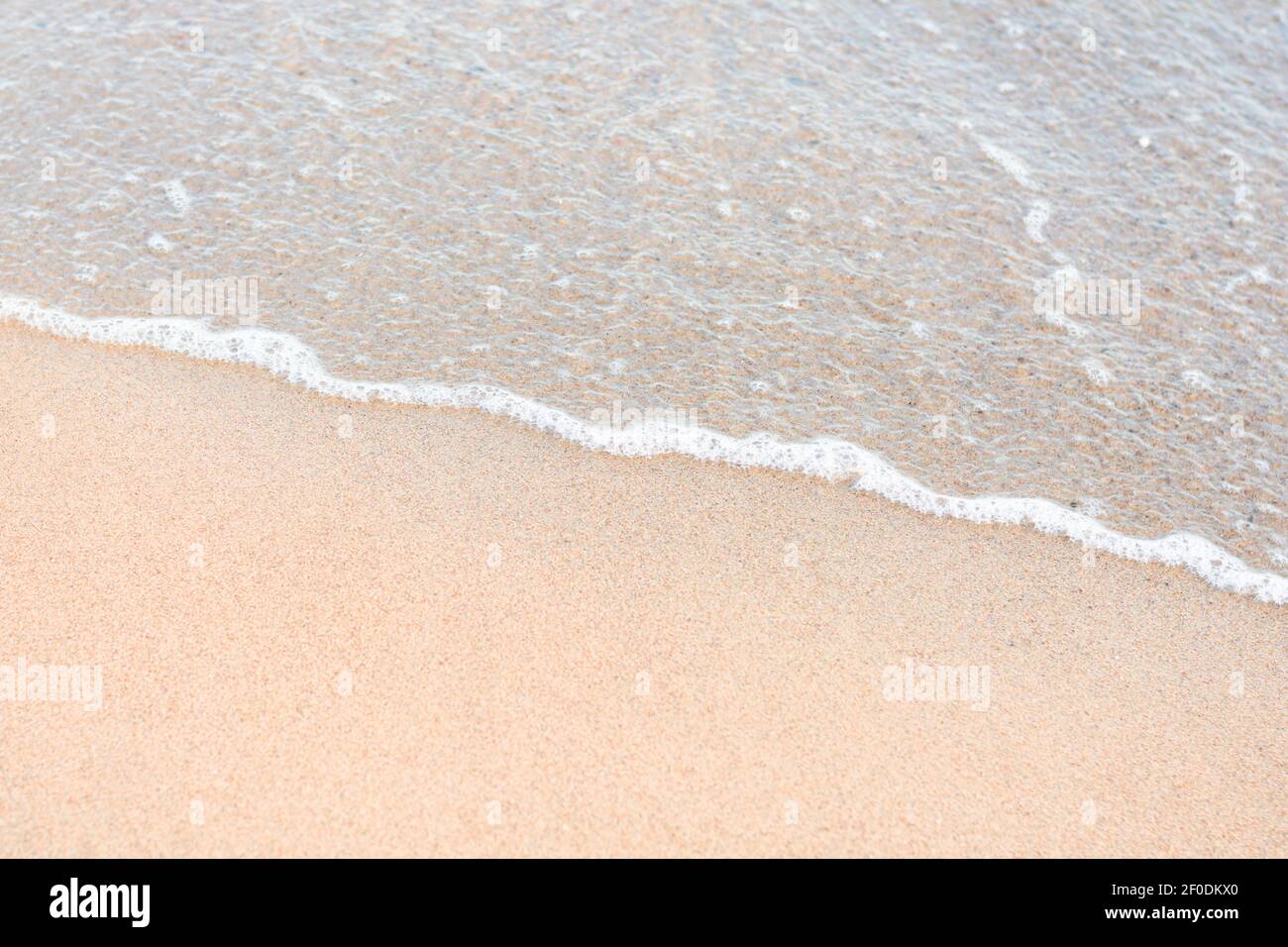 Wave rolls over sandy shore hi-res stock photography and images - Alamy