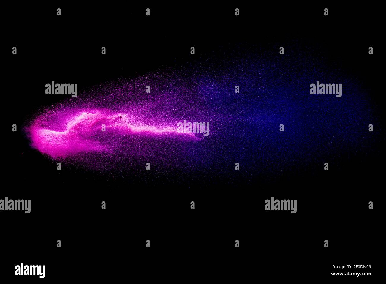 Abstract Blue Pink colored sand splash against black background. Stock Photo