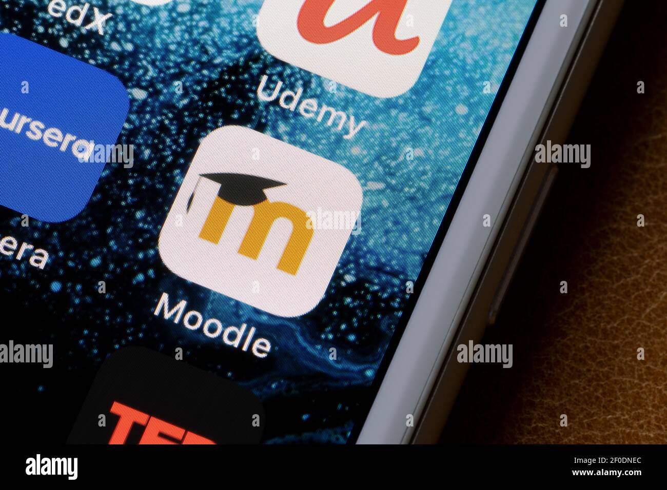 Moodle app icon is seen on an iPhone. Moodle is a Learning Platform or course management system (CMS) - a free Open Source software package. Stock Photo