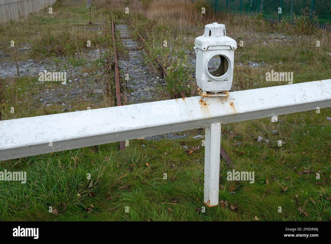 Antique vintage signal lamp on a barrier at derelict railway. Stock Photo