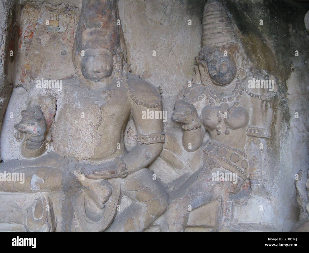 Ancient sculptures carved on stone of Hindu God Shiva and Goddess Parvati in a temple wall at Kanjipuram Tamilnadu India clicked on  11 January 2009 Stock Photo