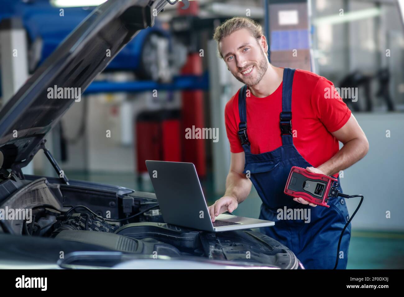 Car mechanic with laptop and special device Stock Photo Alamy