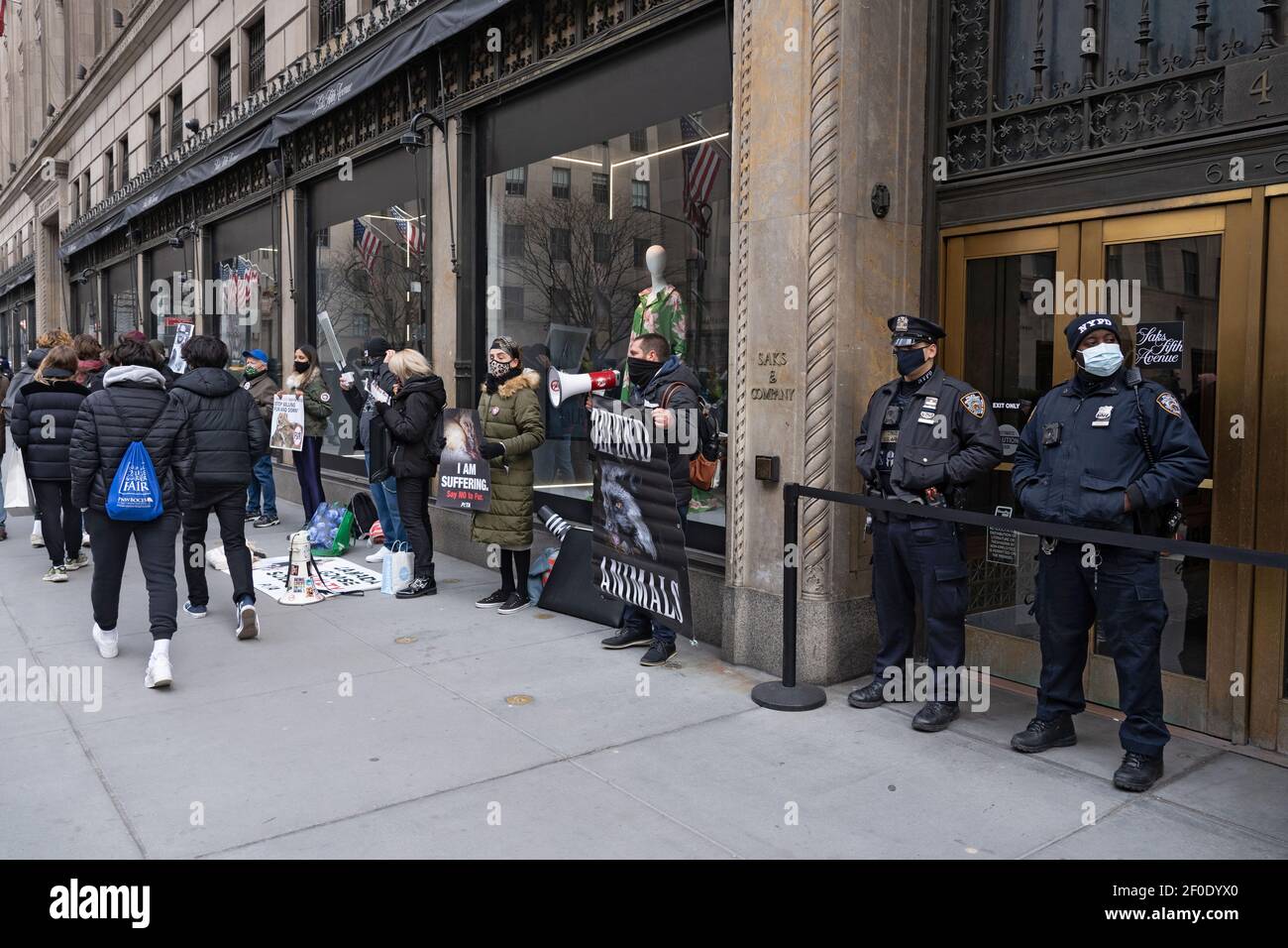 NEW YORK, NY - MARCH 6: NYPD Police Officers secure the store entrances  during a Canada Goose protest in front of Saks Fifth Avenue flagship Store  on March 6, 2021 in New