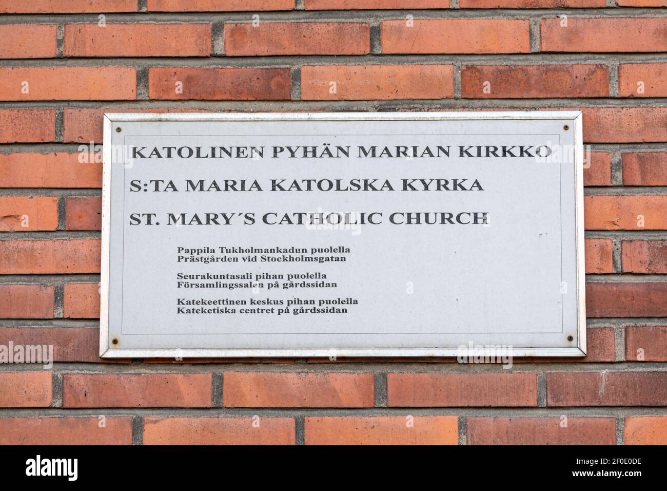 St. Mary's Catholic Church sign on brick wall in Meilahti district of Helsinki, Finland Stock Photo