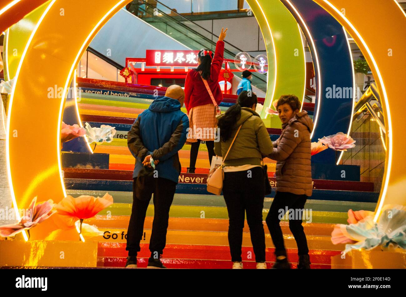 Posing in a colorful tunnel for Women’s Day in the Super Brand Mall in Shanghai’s Lujiazui, Pudong District, China. Stock Photo