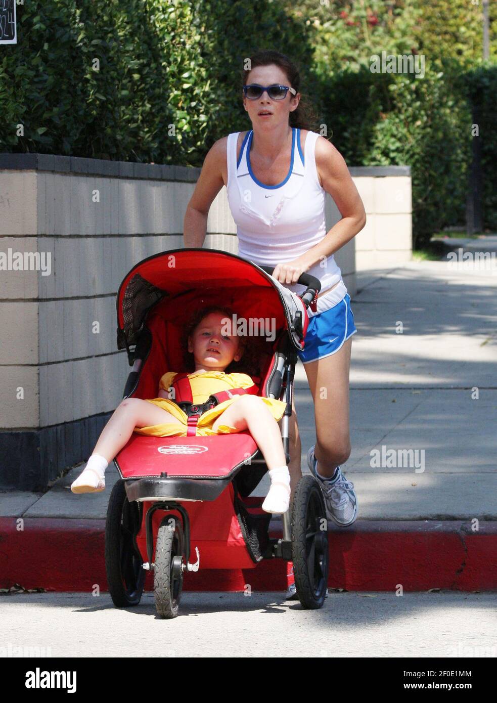 LOS ANGELES: Anna Friel the star of USA comedy Pushing Daisies looks great as she jogs while pushing baby Gracie in the Hollywood Hills. British actress Anna was joined by a friend as they pounded the streets under the Californian sun on Thursday 9th October in Los Angeles. Stock Photo