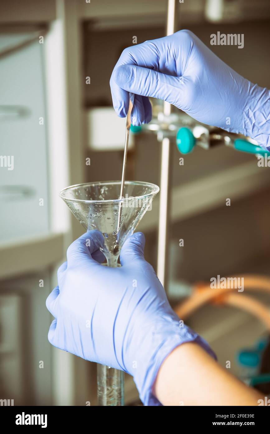 Working With A Glass Funnel In The Lab Stock Photo Alamy