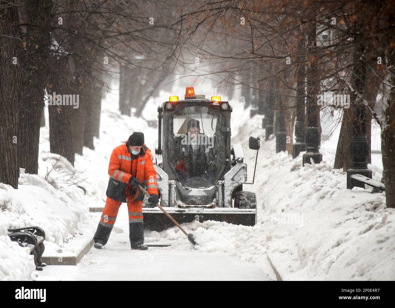 Moscow, Russia. 7th Mar, 2021. Street cleaners remove snow in a street. On 7  March, Moscow
