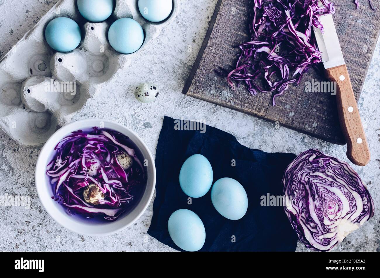 Dyed blue Easter eggs painted with natural dye red cabbage on grey ...