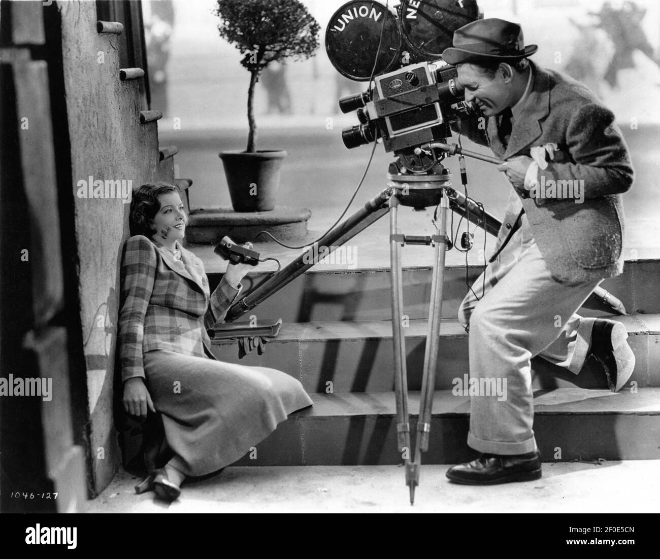MYRNA LOY and CLARK GABLE with Newsreel Movie Camera in TOO HOT TO