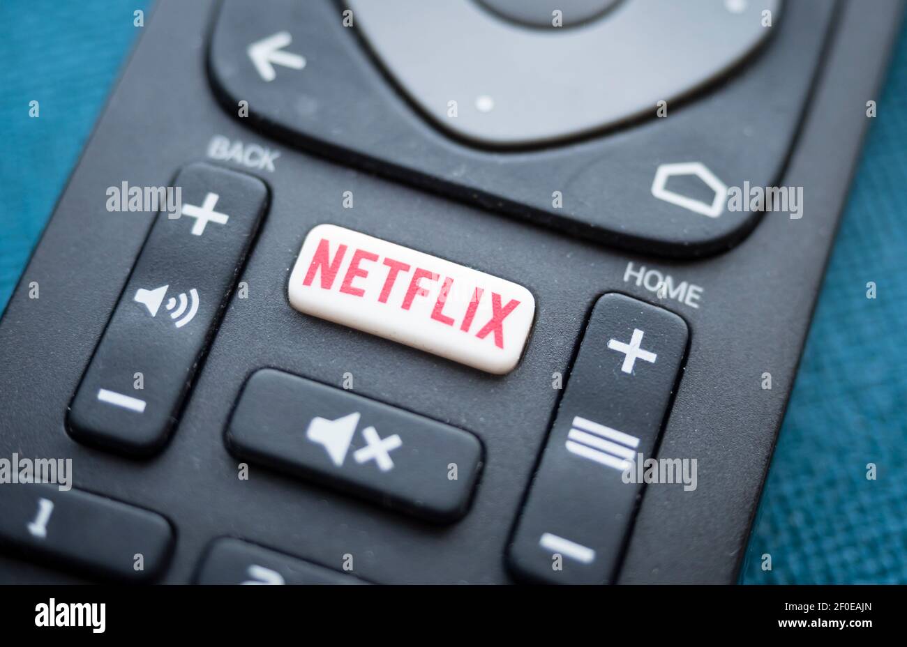 Close-up of the Netflix logo on the button of a TV remote control Stock Photo