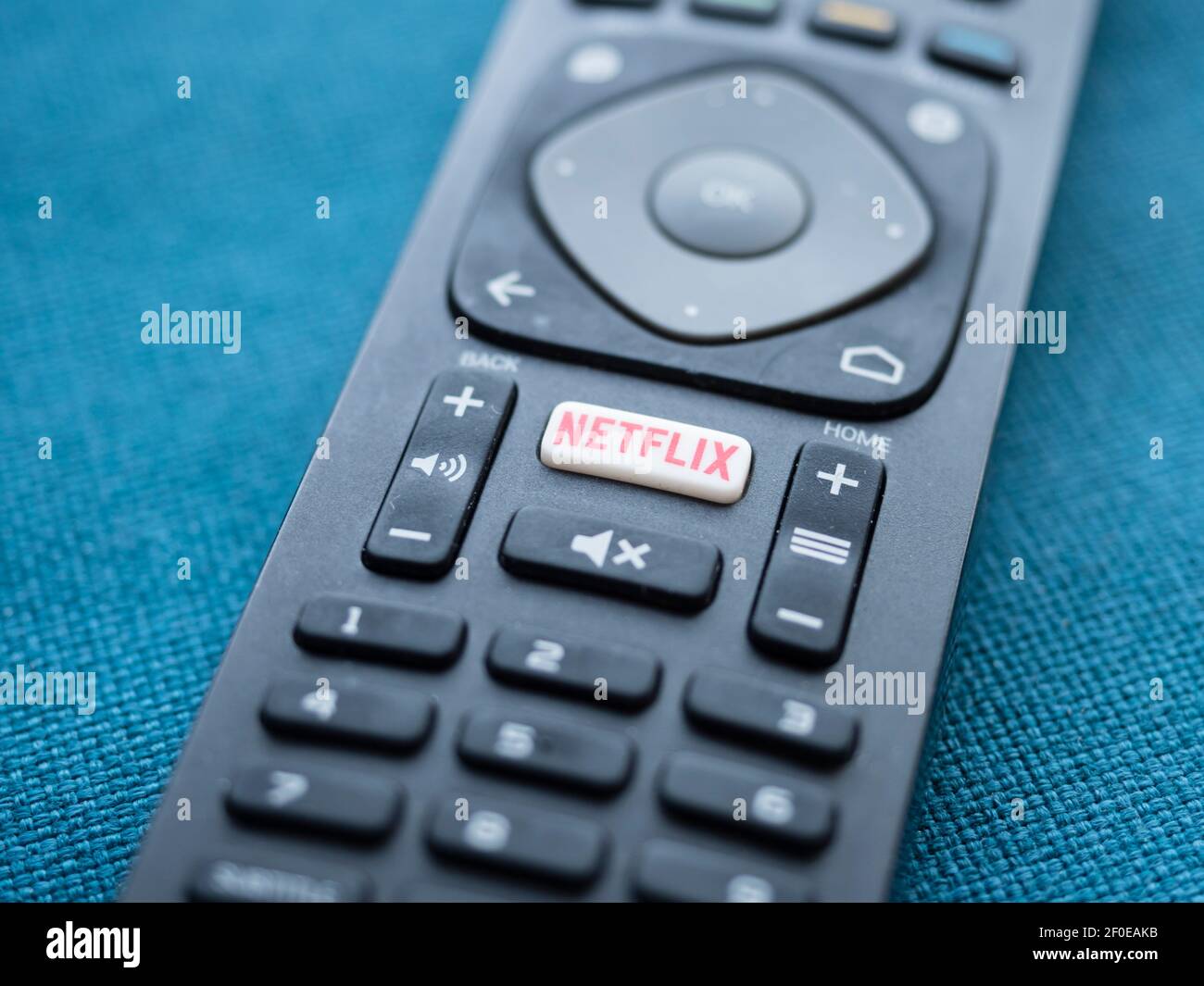 Close-up of the Netflix logo on the button of a TV remote control Stock Photo