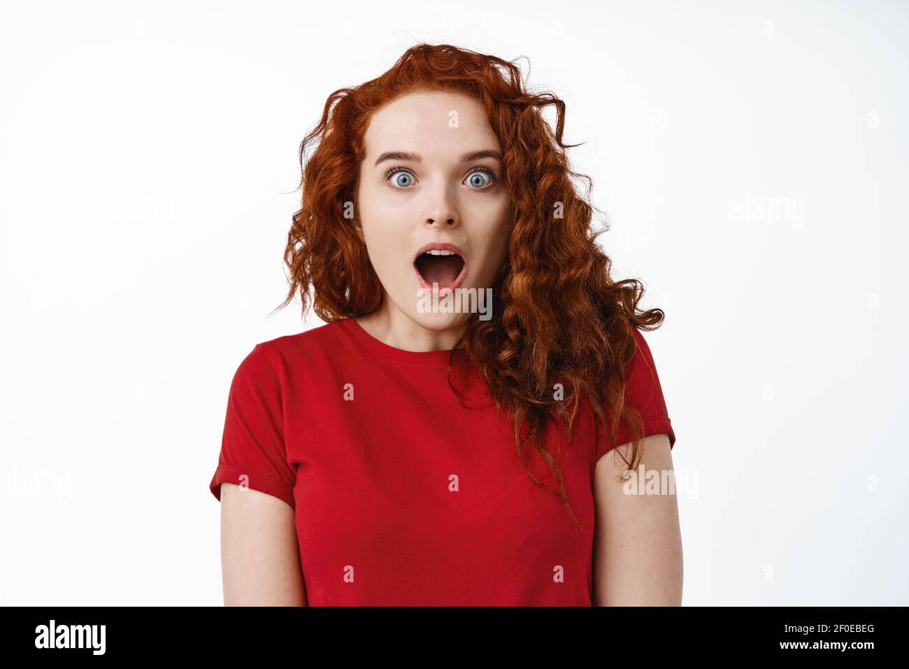 Wow so cool. Excited and surprised young ginger girl, drop jaw and