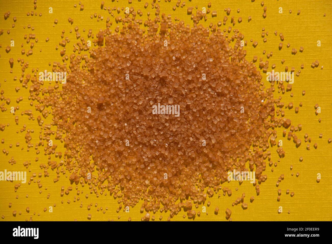 brown sugar cubes background on yellow colored paper sheet Stock Photo