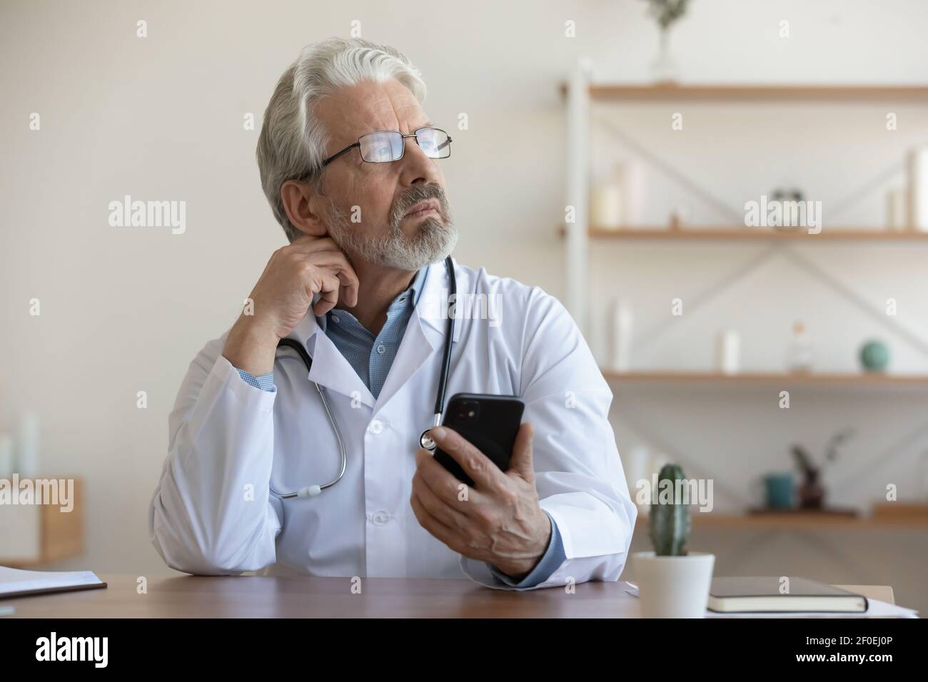 Pensive middle aged doctor hi-res stock photography and images - Alamy