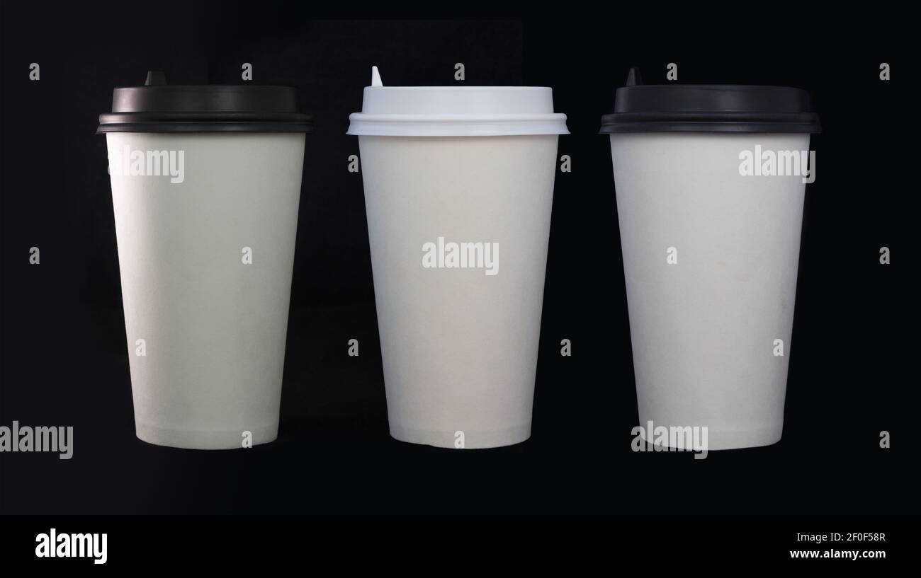 Three disposable coffee cups on black background Stock Photo
