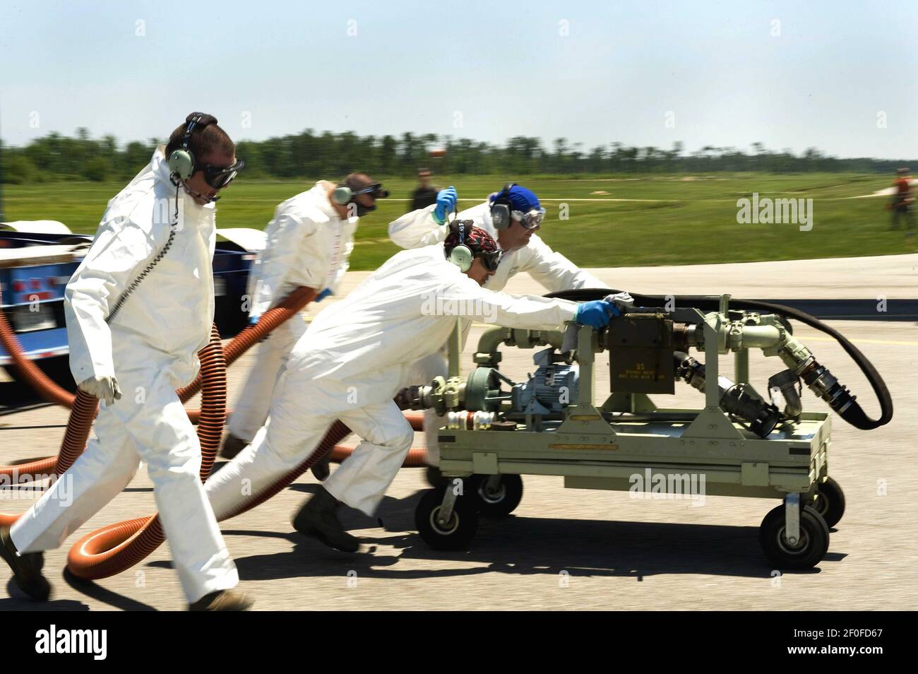 4 May 2010 - Stennis International Airport, Mississippi - A team of U.S. Air Force aerial spray aircraft maintainers from the 910th Aircraft Maintenance Squadron at Youngstown-Warren Air Reserve Station, Ohio, move a chemical pump into position in order to refill a chemical dispersing C-130 aircraft at Stennis International Airport in Kiln, Miss. on May 4, 2010. Members of the 910th Airlift Wing were in Mississippi to help with the oil spill clean up. The 910th AW specializes in aerial spray and is the Department of DefenseÃ•s only large area fixed wing aerial spray unit. Photo Credit: Adrian  Stock Photo