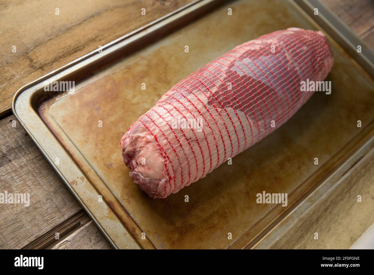 A raw British beef roasting joint on a metal baking tray. England UK GB