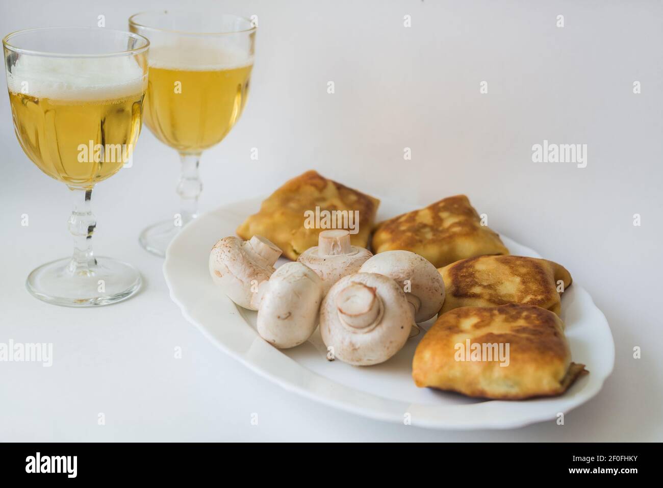 Pancakes with fillings and mushrooms on plate Stock Photo