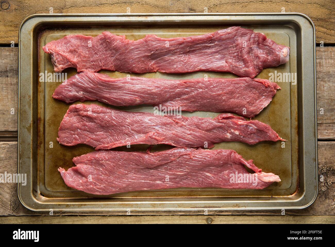 Strips of raw British beef that have been cut in preparation for making biltong. England UK GB Stock Photo