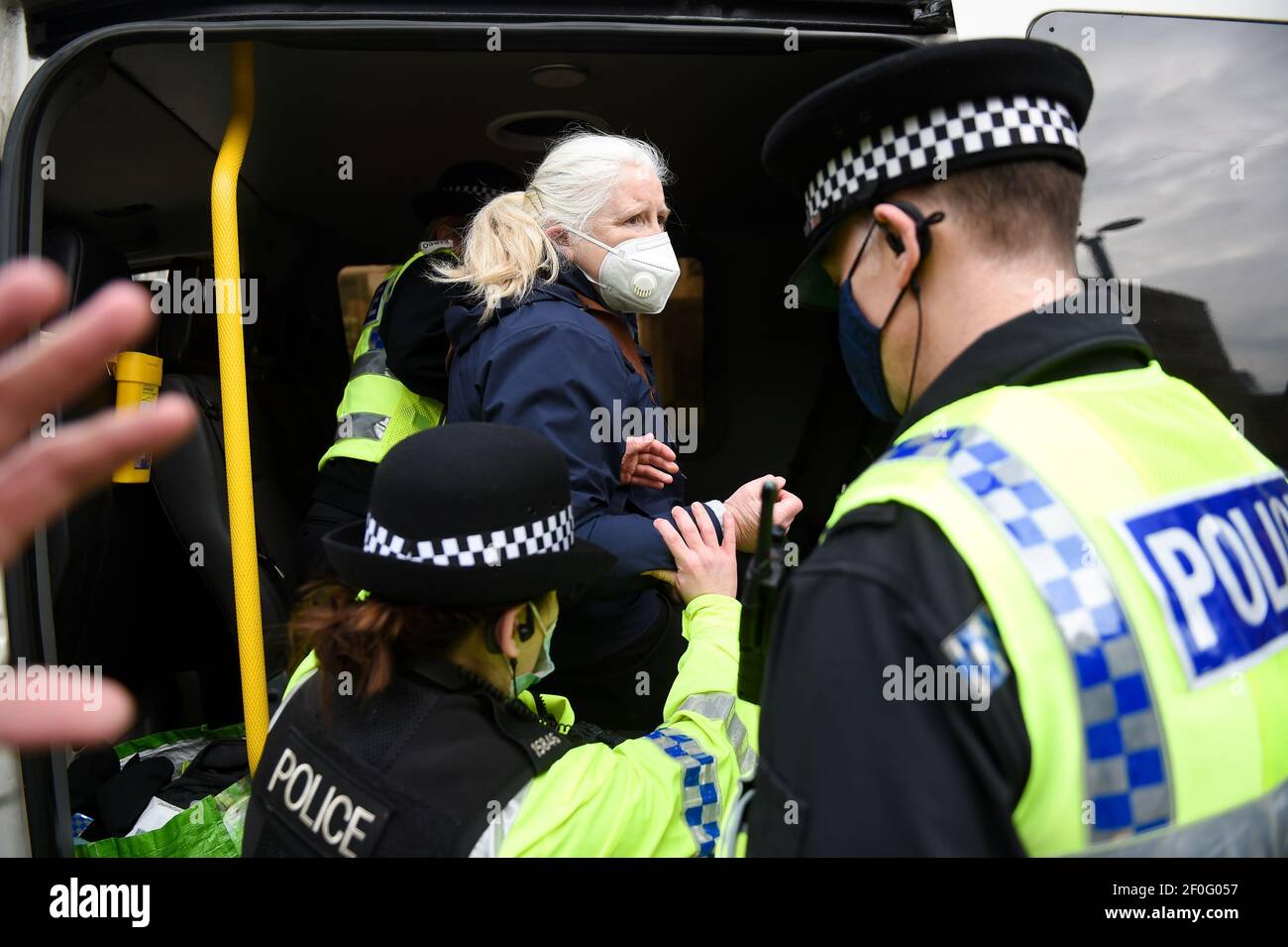 Police detain an NHS worker after breaking up a protest in Manchester, over the proposed 1% pay rise for NHS workers from the Government. Picture date: Sunday March 7, 2021. Stock Photo