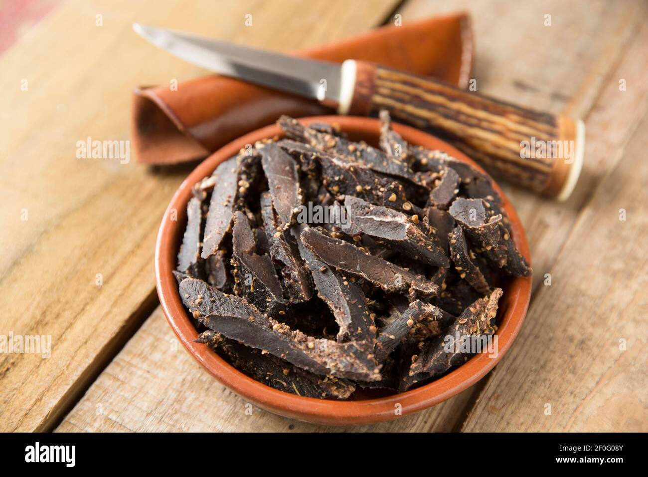 Biltong made from fallow deer venison that has been air dried and cured using salt, vinegar and sugar and various spices including crushed coriander s Stock Photo